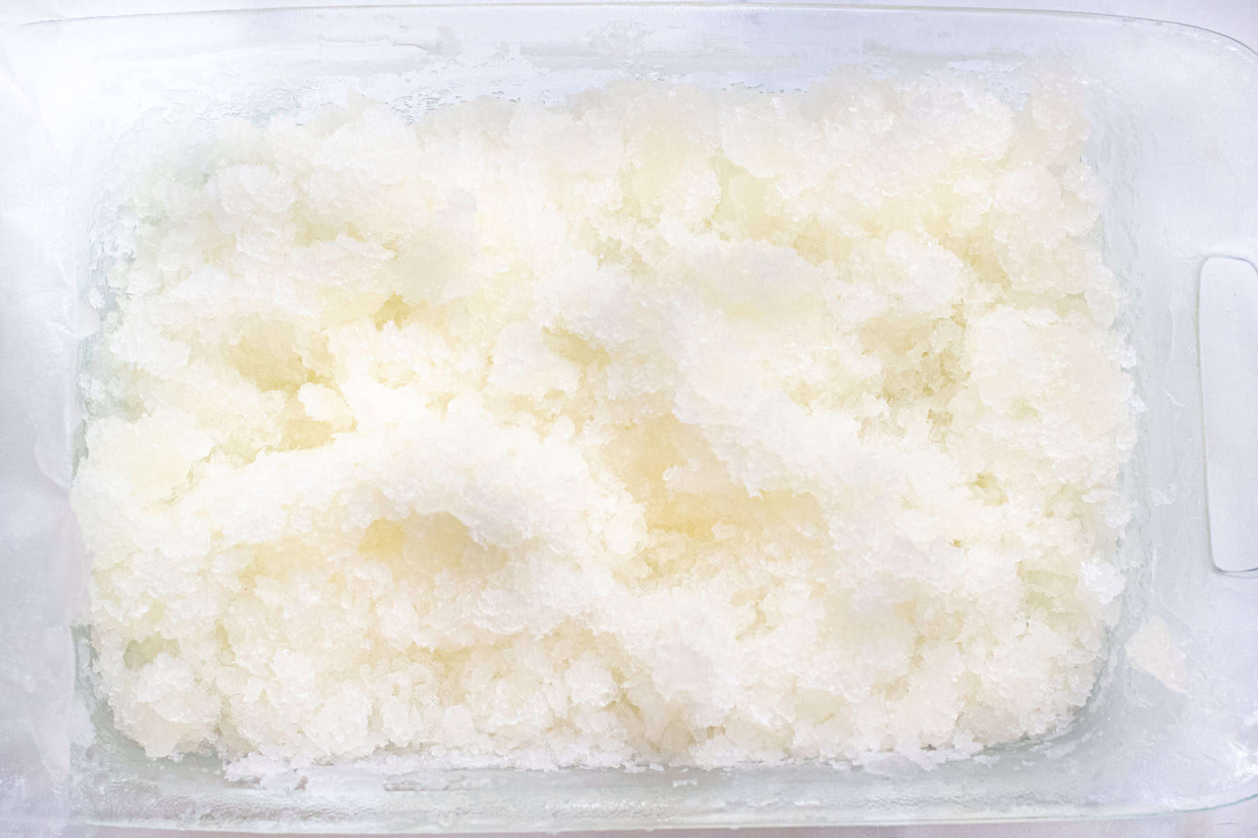 a baking tray of shaved ice.