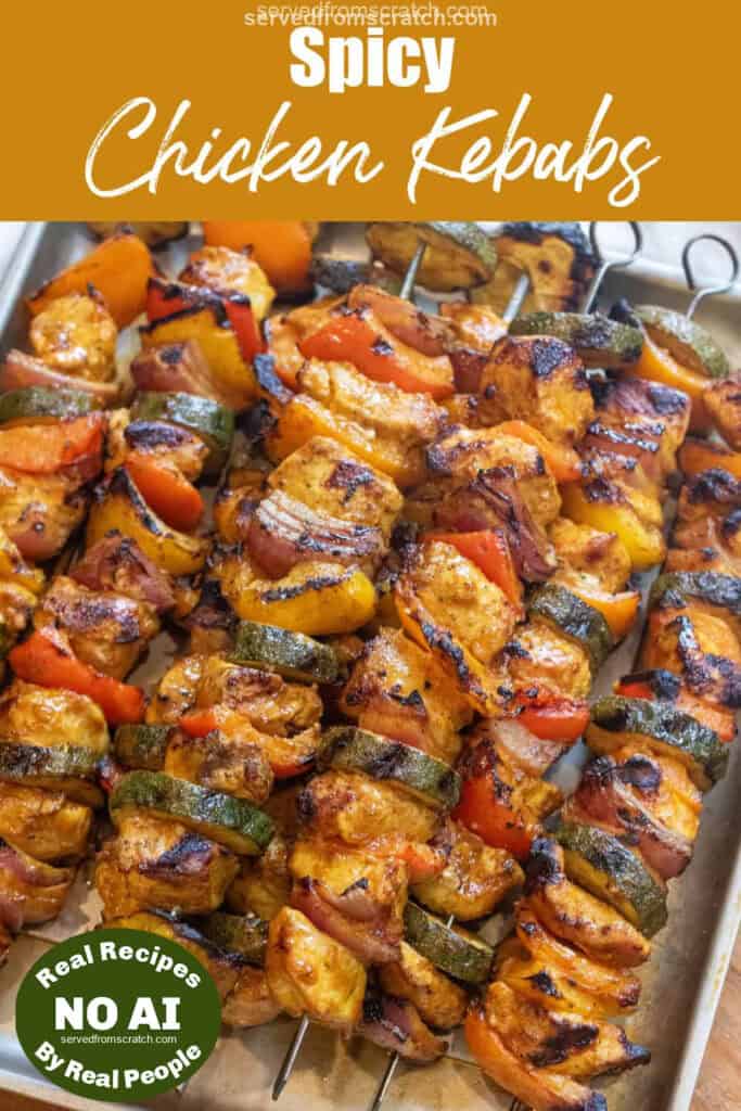 a tray of cooked chicken and pepper kebabs and Pinterest pin text with NO AI sticker.
