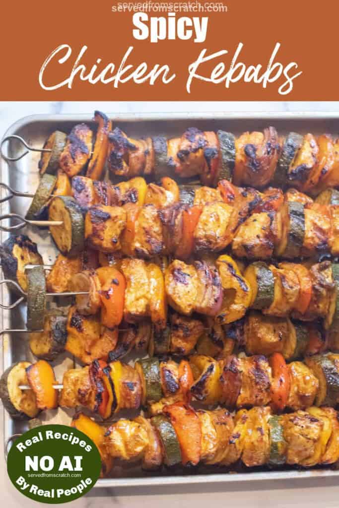 a tray of cooked chicken and pepper kebabs and Pinterest pin text with NO AI sticker.