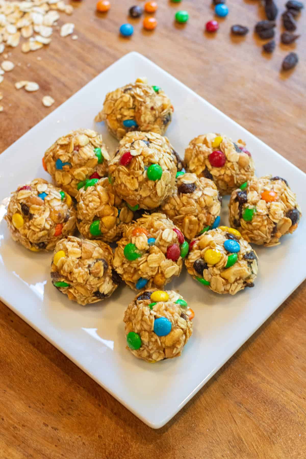 a tray of oat balls with raisins and m&ms.