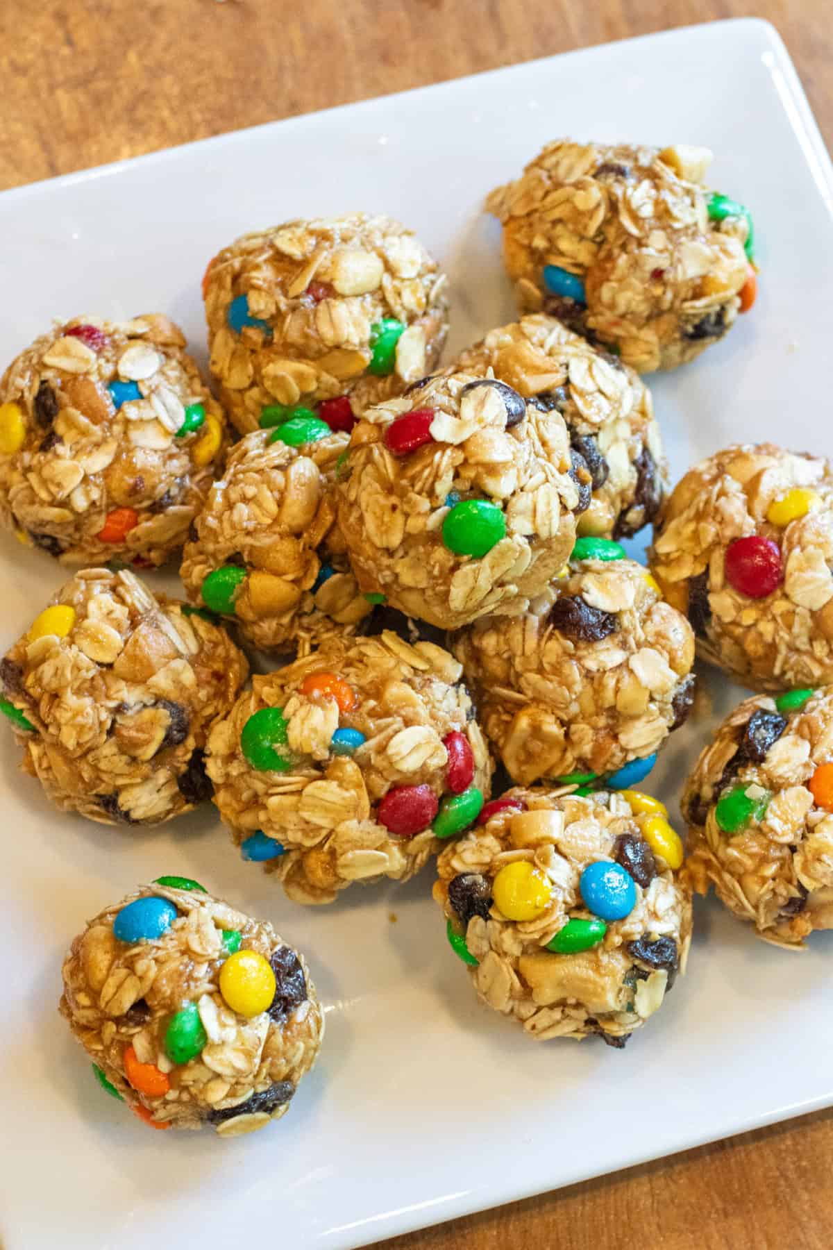 a tray of oat balls with raisins and m&ms.