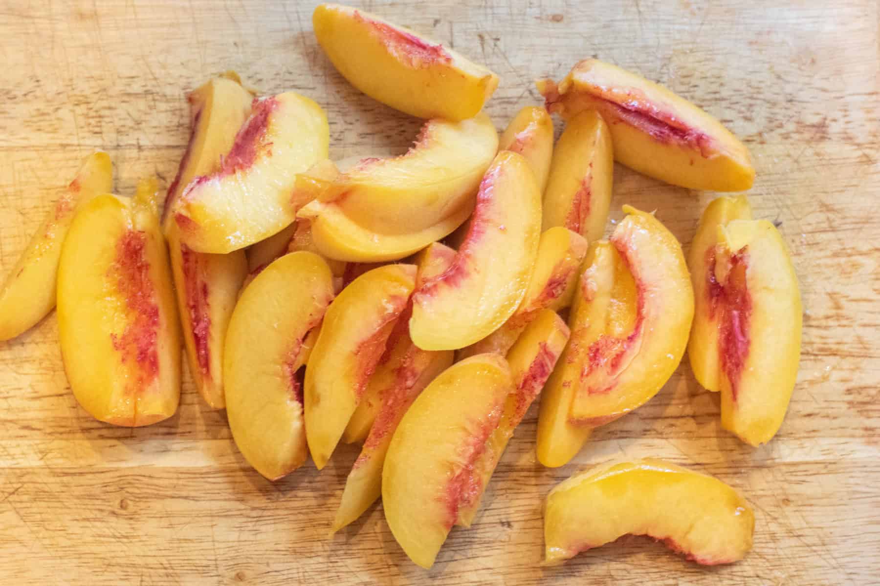 sliced peaches on a cutting board.
