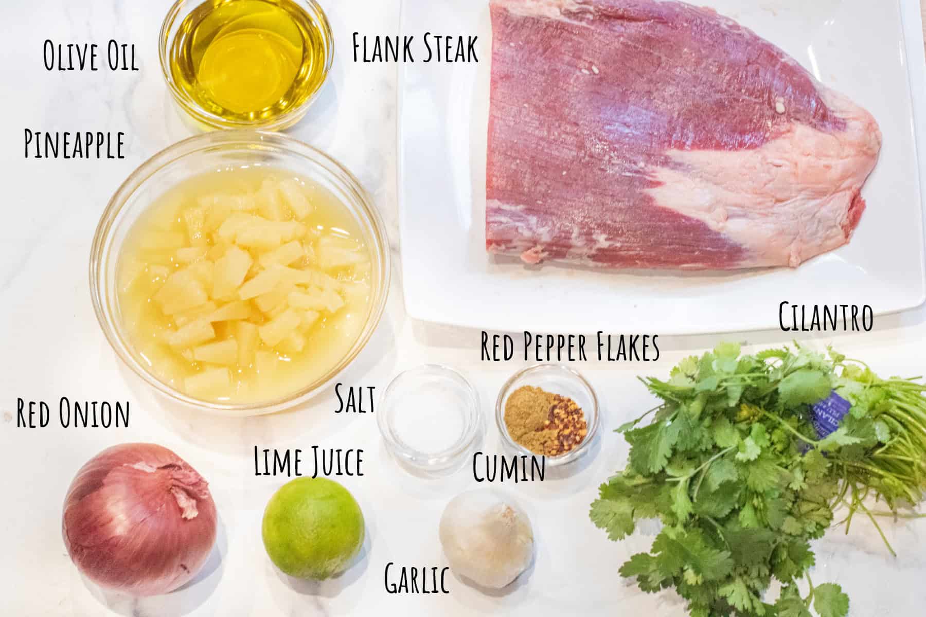 a flank steak, olive oil, canned pineapple, red onion, spices, cilantro, lime, garlic, and salt in bowls or on plates and labeled.