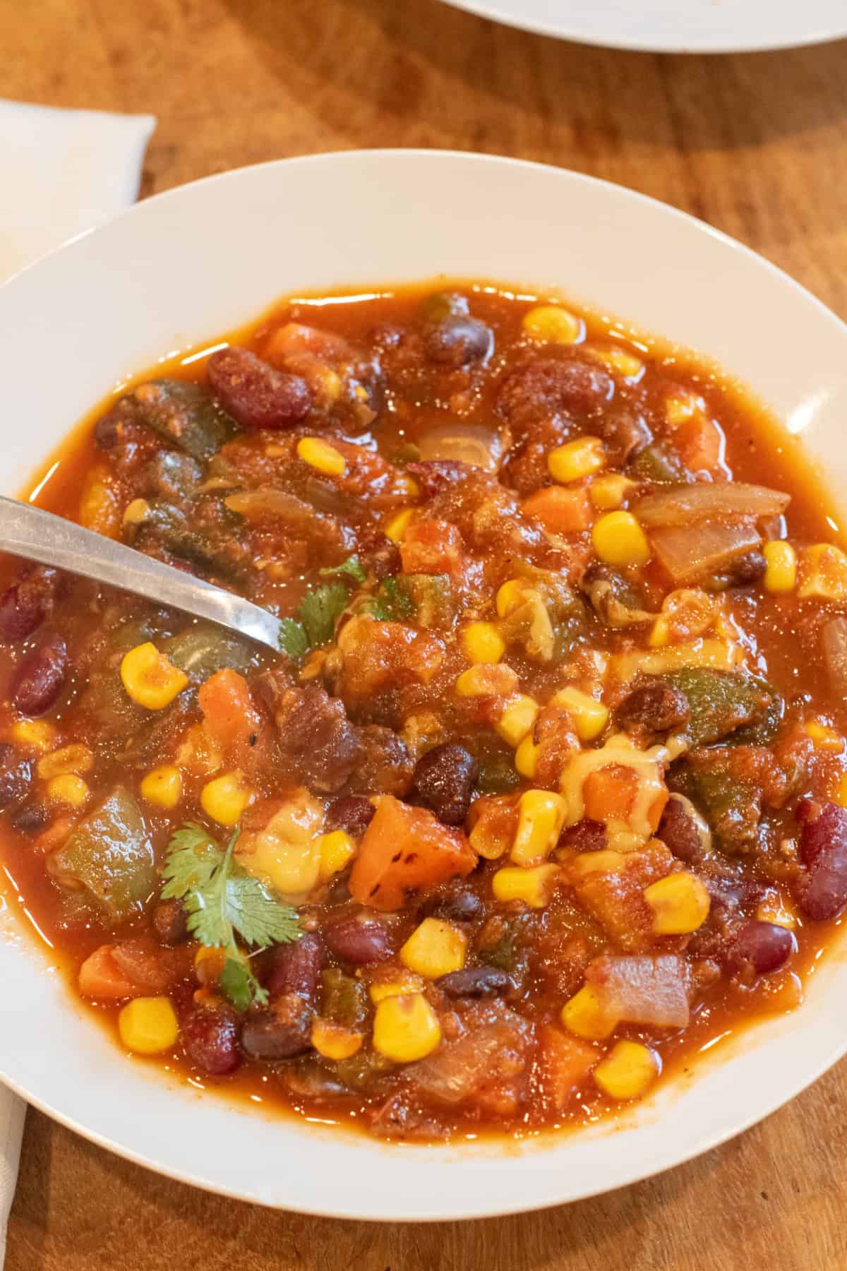 a bowl of chili with a spoon in it.