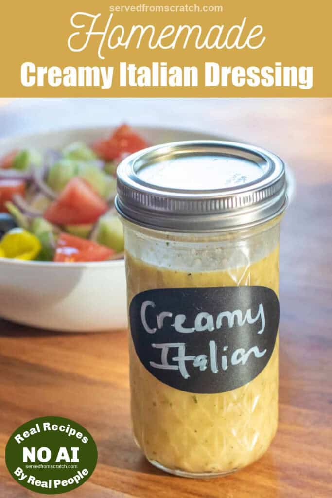a jar of italian salad dressing labeled creamy italian in front of a bowl of salad with Pinterest pin text with NO AI sticker.