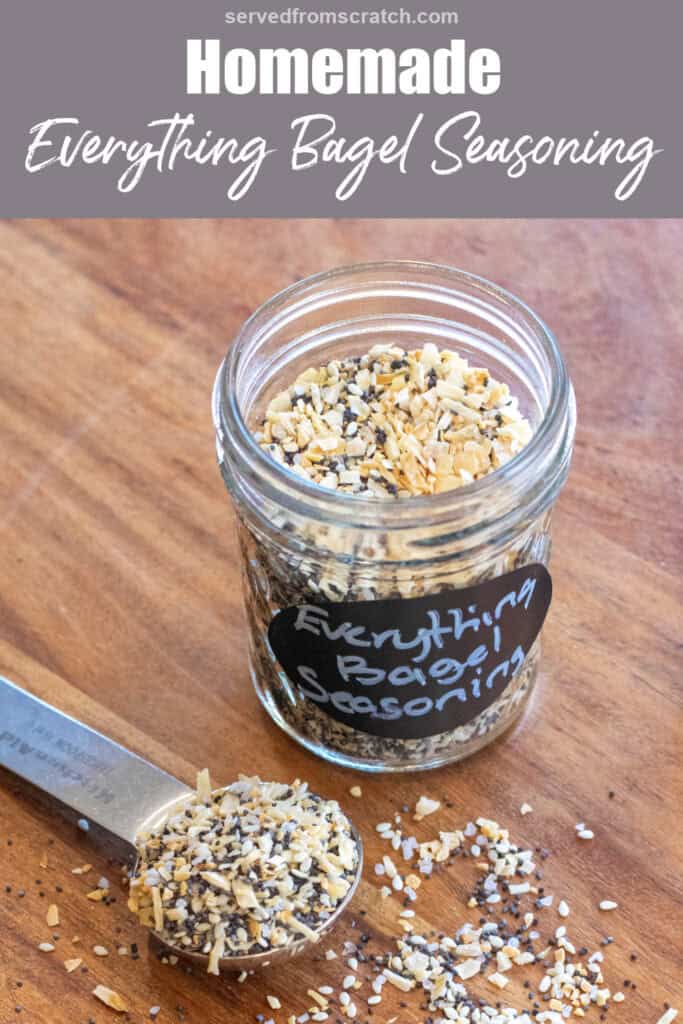 a labeled jar of everything bagel seasoning open with a tablespoon filled with seasoning next to it with Pinterest pin text.