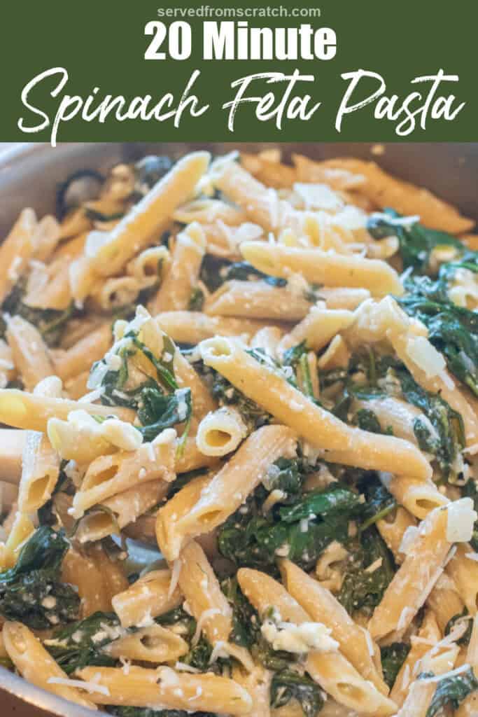 a close up of pasta in a pan with spinach and feta and Pinterest pin text.