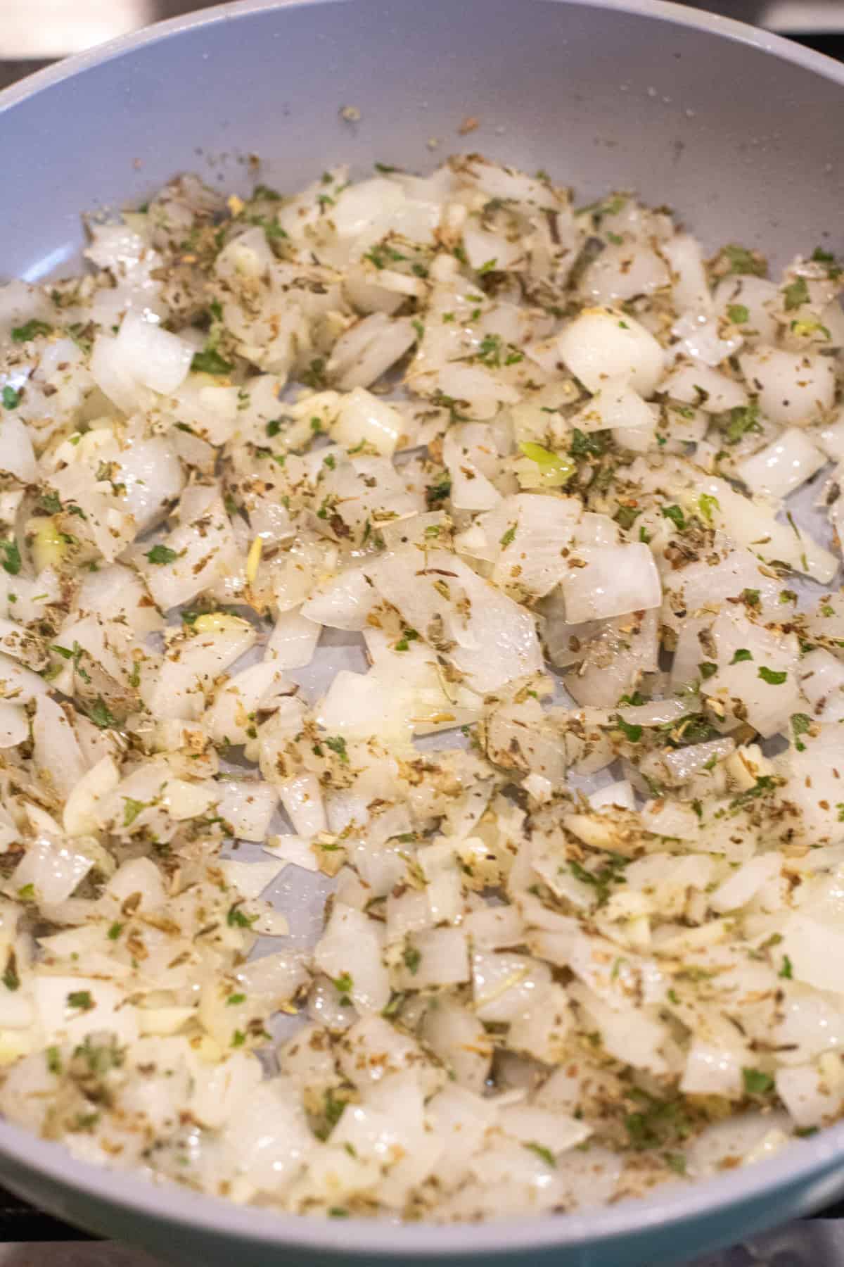 a pan of sauteed onion, garlic, and Italian seasoning.