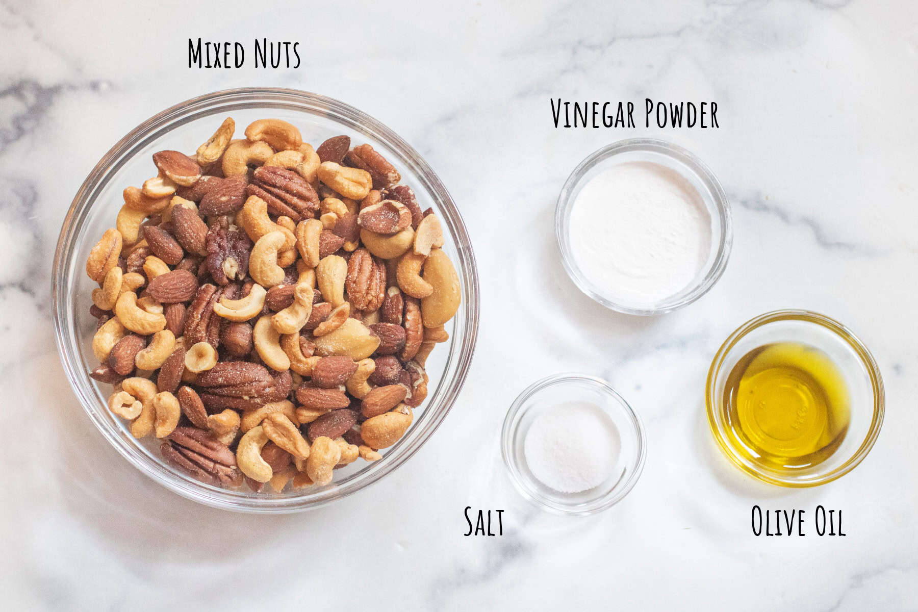 a bowl of mixed nuts, olive oil, and vinegar powder and salt.