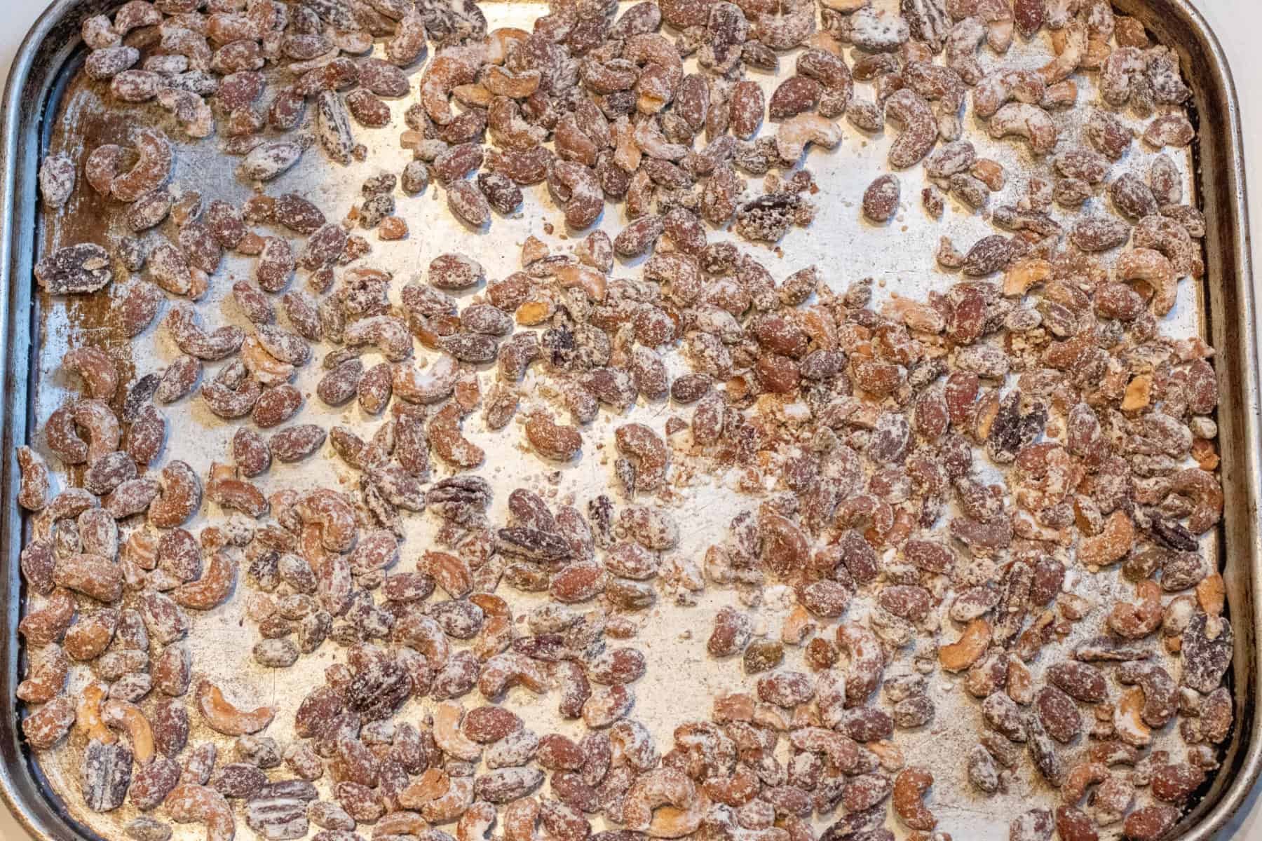 a tray of vinegar powder coated nuts on a tray.