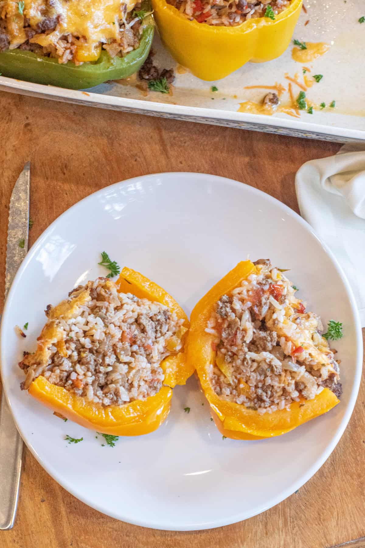 a stuffed pepper with rice and meat halved on a plate.