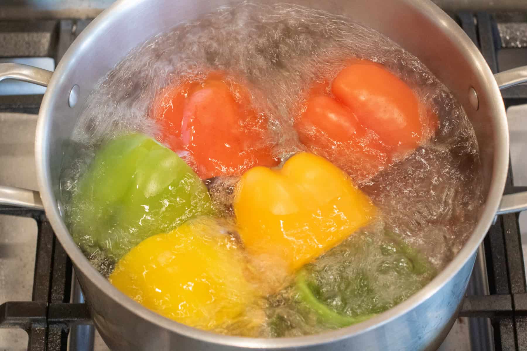 colored bell peppers in boiling water.