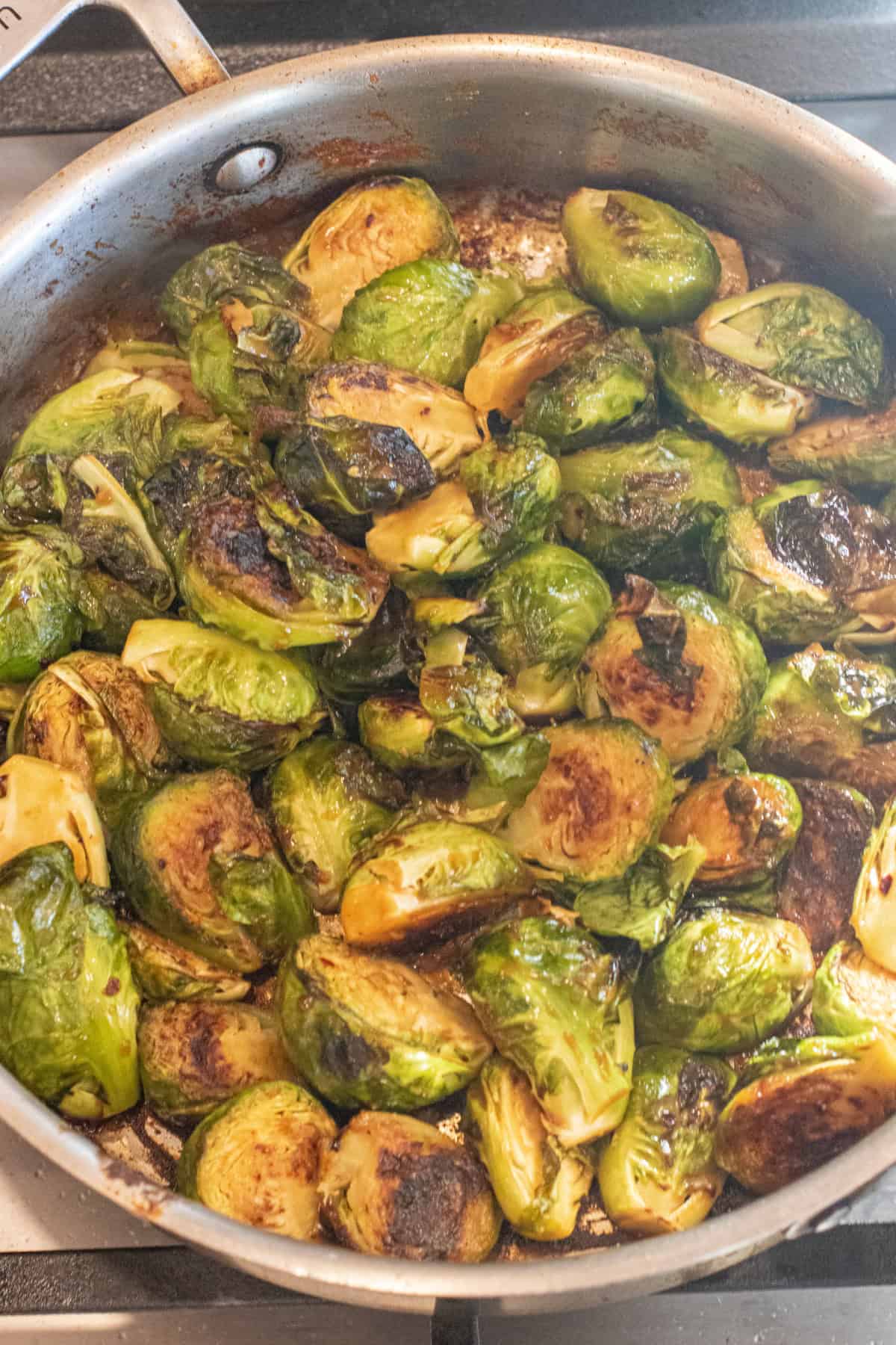 a saute pan of a havled and glazed Brussels Sprouts.