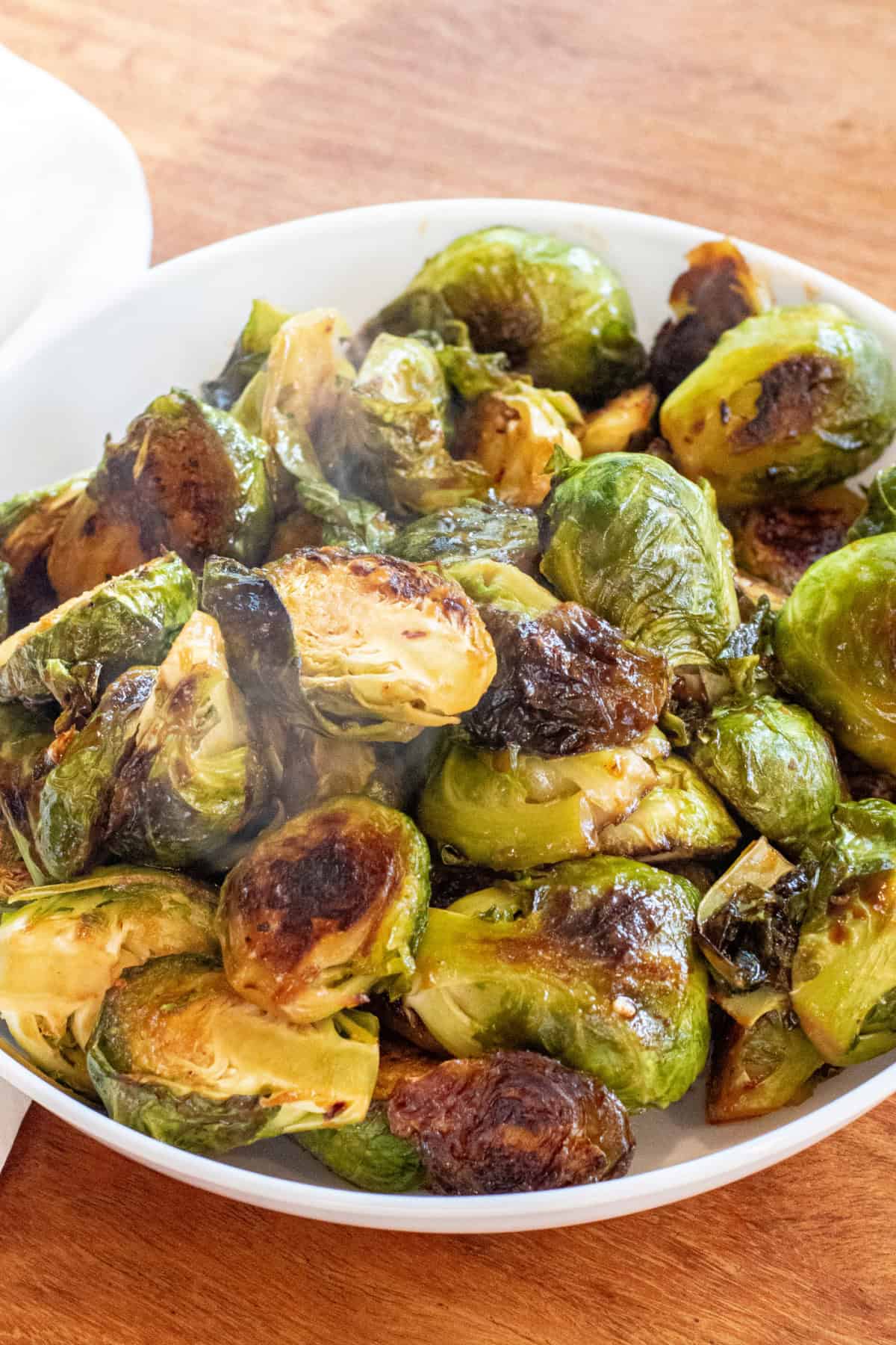 a large wide bowl of roasted and glazed brussels sprouts.