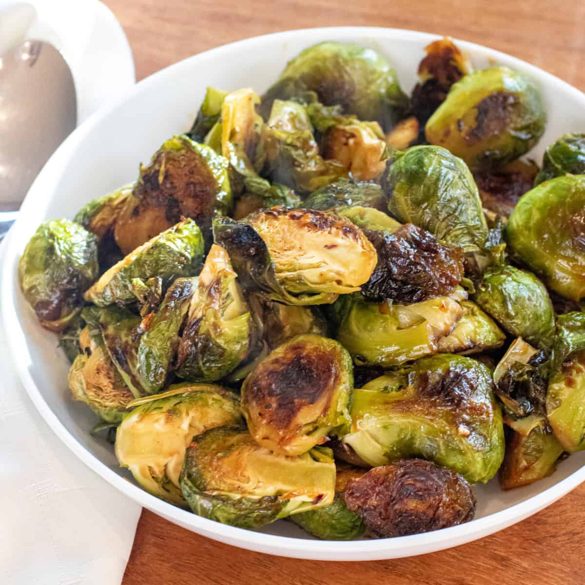 a large wide bowl of roasted and glazed brussels sprouts.