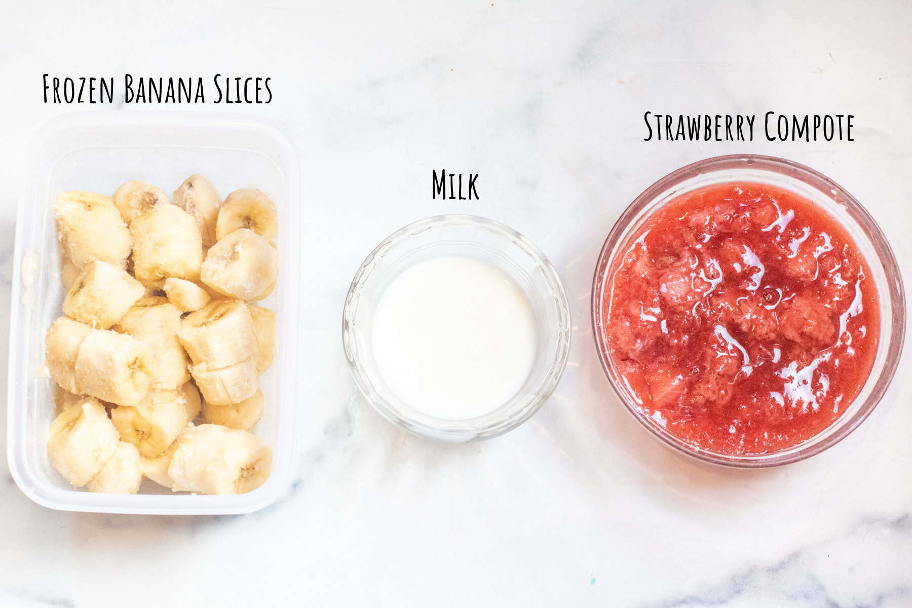 a container of frozen sliced bananas, milk, and a bowl of strawberry compote.