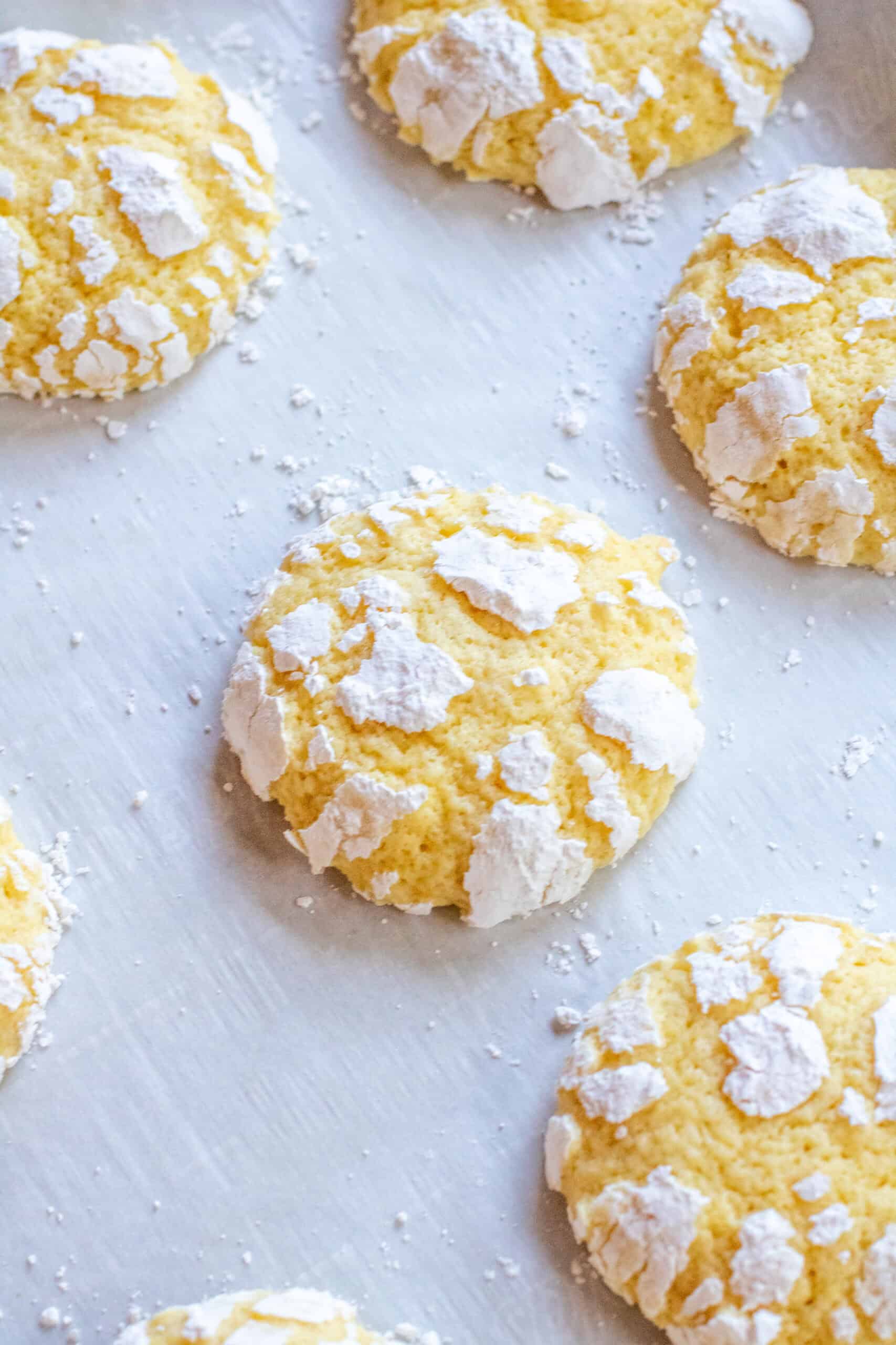 baked lemon crinkle cookies on parchment paper.