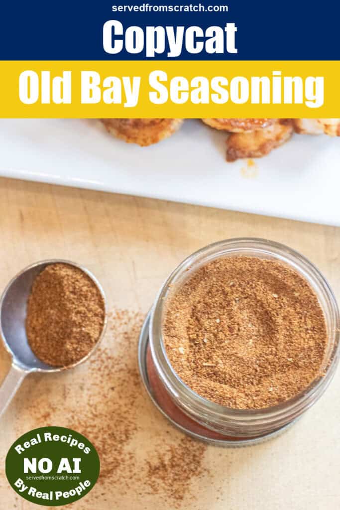an overhead of a small mason jar of a spice blend mix with a measuring spoon next to it an some split in front of a plate of cooked shrimp with Pinterest pin text and NO AI sticker.