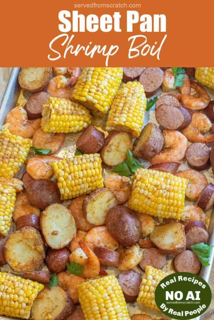 an overhead of a sheet pan with cooked corn on the cob pieces, shrimp, and potatoes with Pinterest pin text and NO AI sticker.