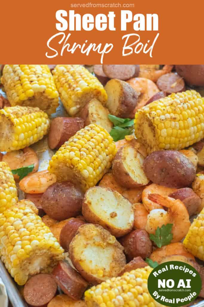 an overhead of a sheet pan with cooked corn on the cob pieces, shrimp, and potatoes with Pinterest pin text and NO AI sticker.