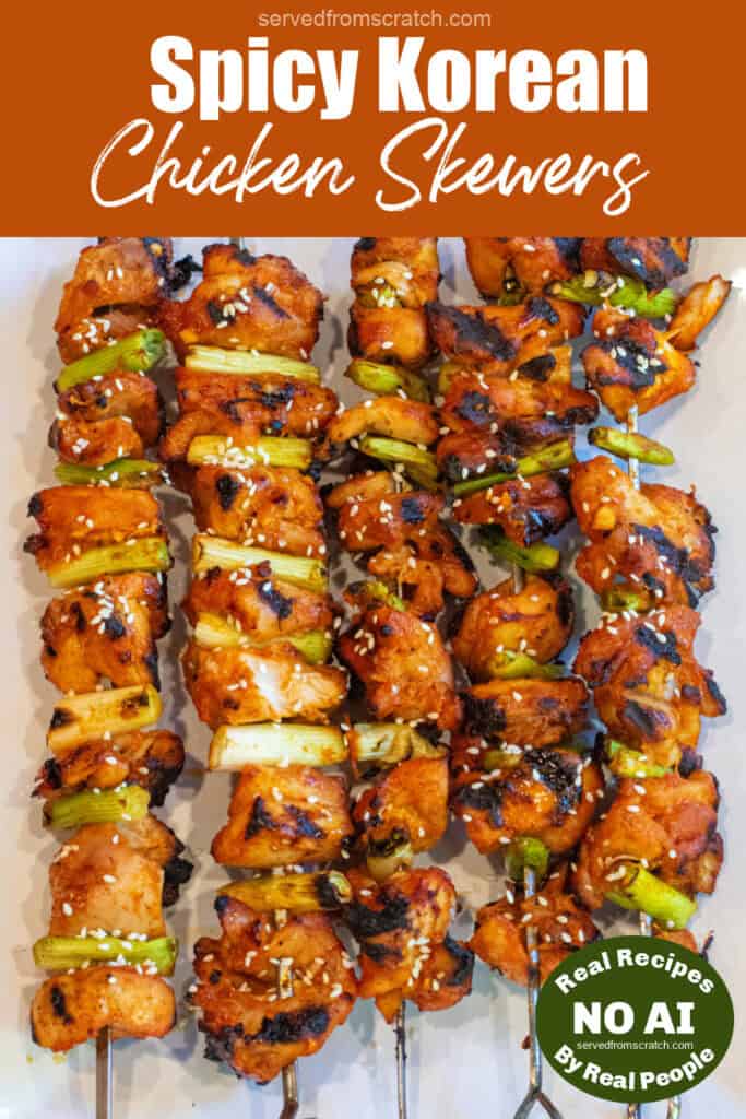 a large plate of grilled chicken skewers with green onion and sesame seeds with Pinterest pin text and NO AI sticker.