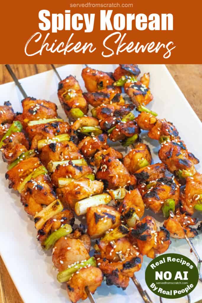 a large plate of grilled chicken skewers with green onion and sesame seeds with Pinterest pin text and NO AI sticker.