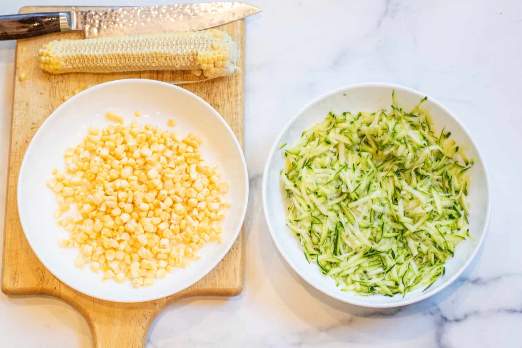bowls of fresh corn and shredded zucchini.