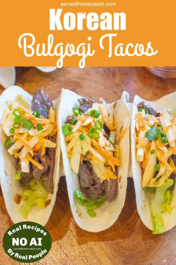 an overhead of 3 tacos in a taco holder with beef, slaw, and green onions on top with Pinterest pin text and NO AI sticker.