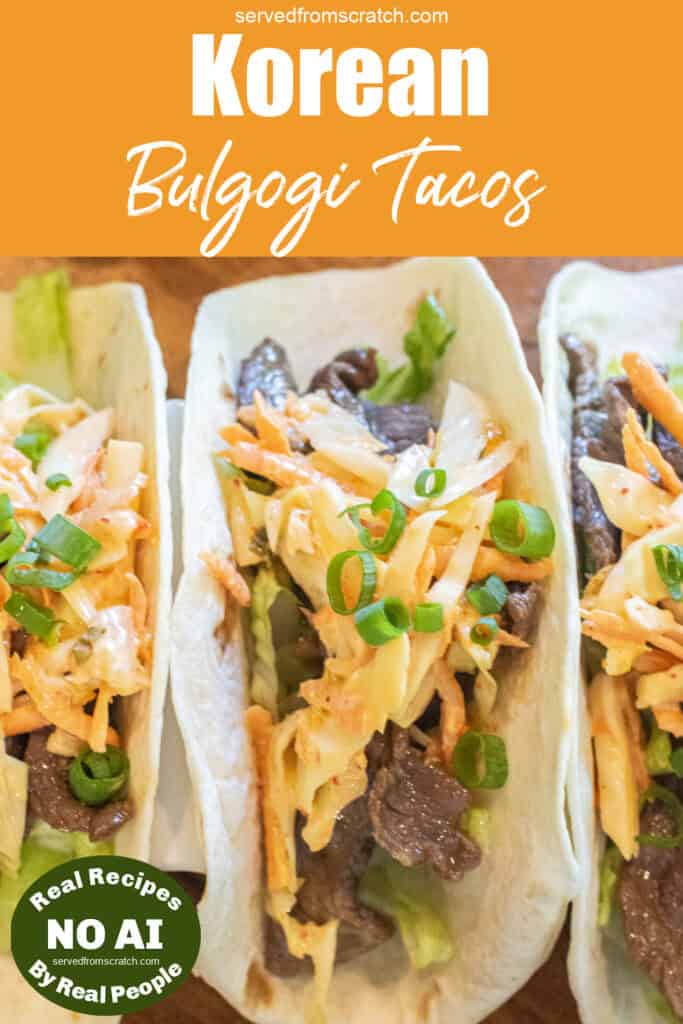 an overhead of 3 tacos in a taco holder with beef, slaw, and green onions on top with Pinterest pin text and NO AI sticker.