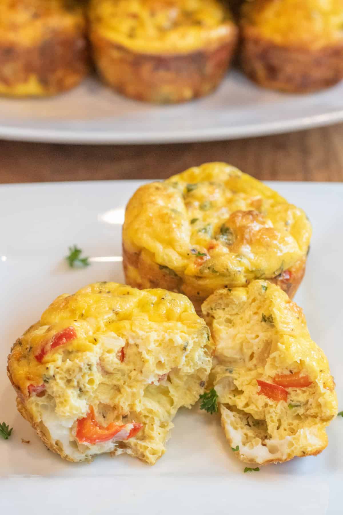 a plate with baked egg cups and one halved.