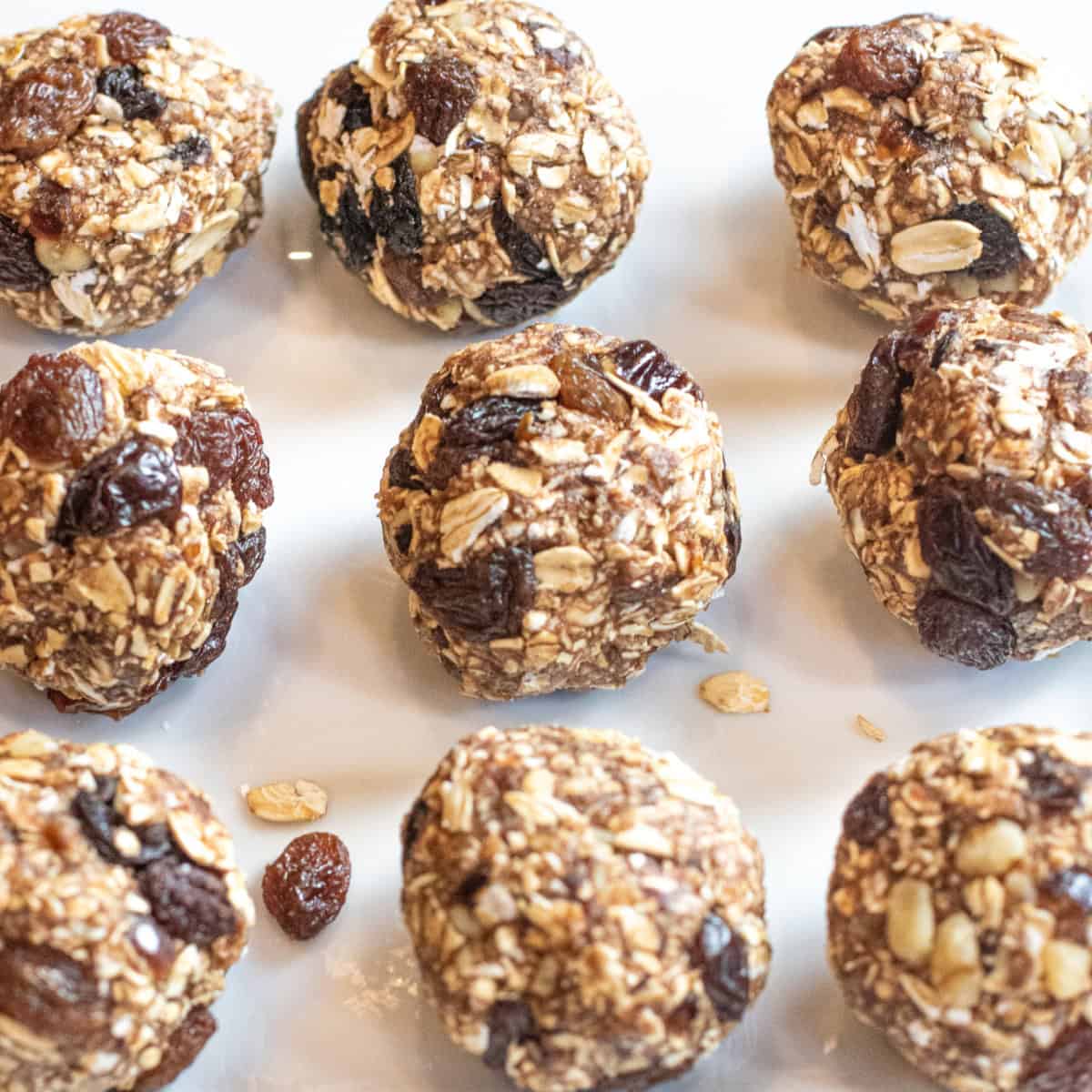 a plate of oat balls with raisins.