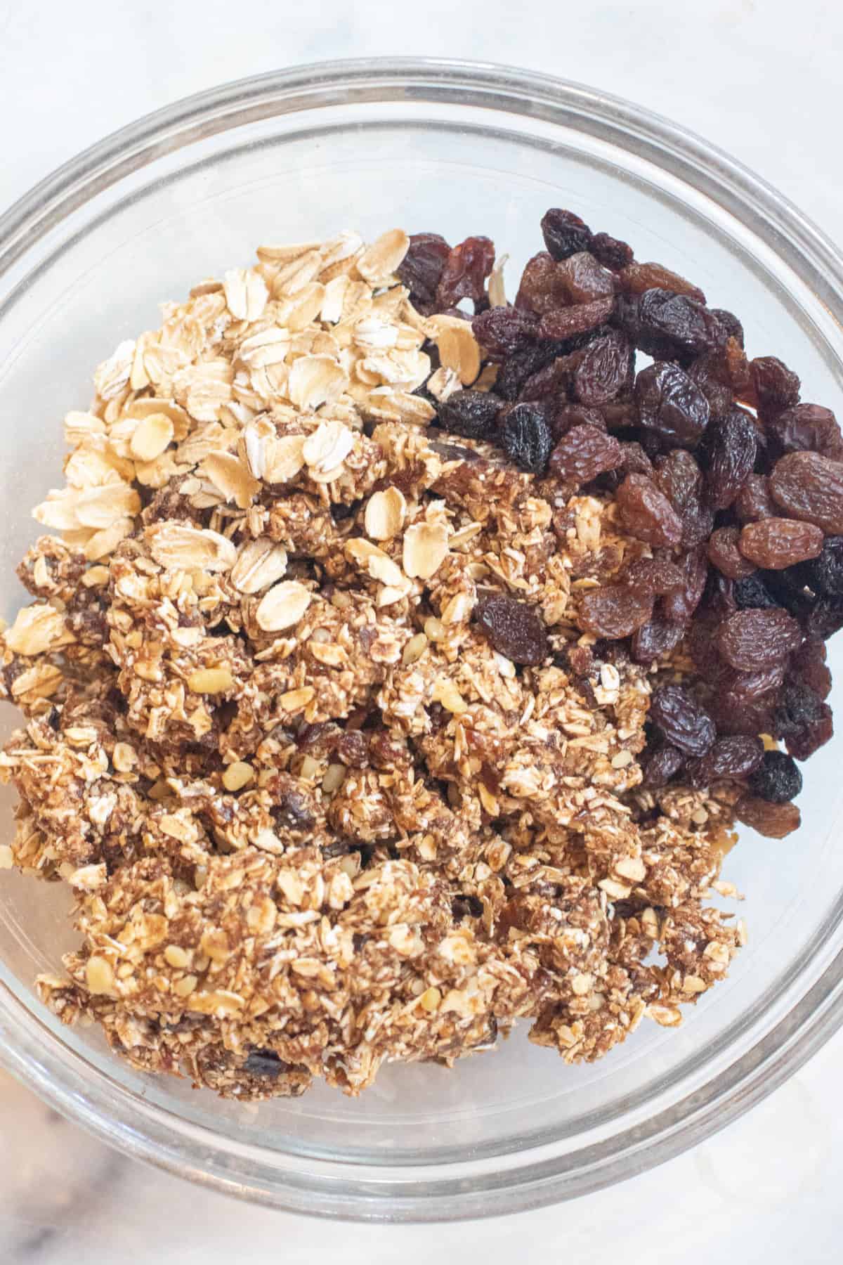 a bowl with the mixed oats and then some additional oats and raisins in a large bowl.
