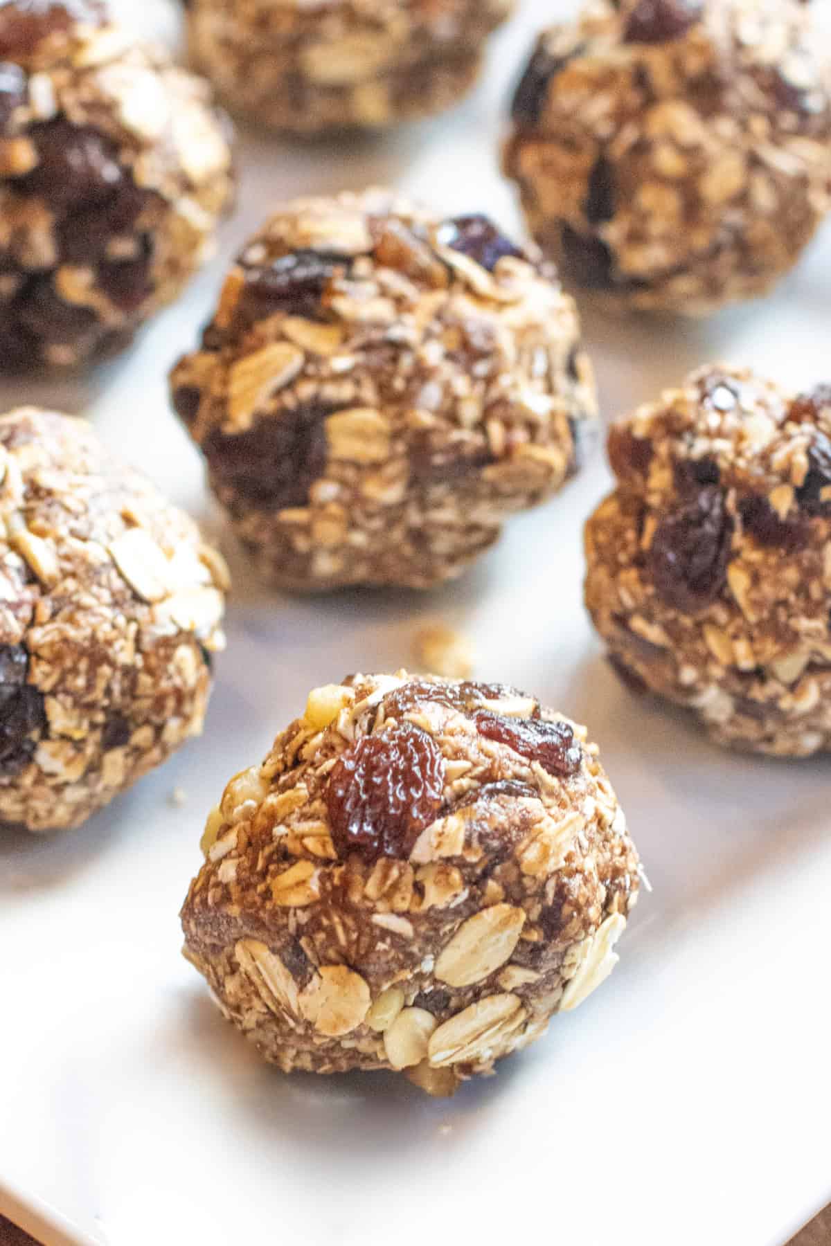 a plate of oat balls with raisins.