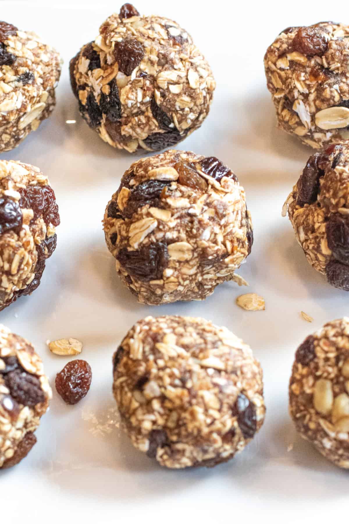 a plate of oat balls with raisins.