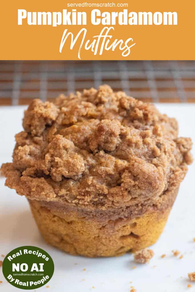 a pumpkin muffin with a crumble on top with Pinterest pin text and NO AI sticker.